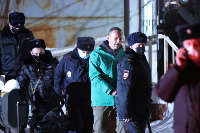 Russian opposition leader Alexei Navalny is escorted by police officers after a court hearing, in Khimki, outside Moscow, Russia, Jan. 18, 2021. (Reuters)