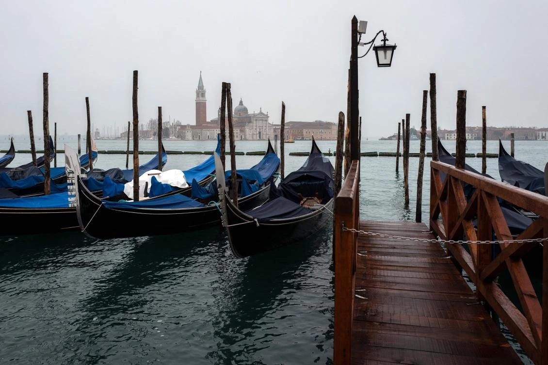 A view shows gondolas moored in Venice on February 7, 2021, as the carnival is being cancelled due to the Covid-19 pandemic. / AFP / Marco Bertorello