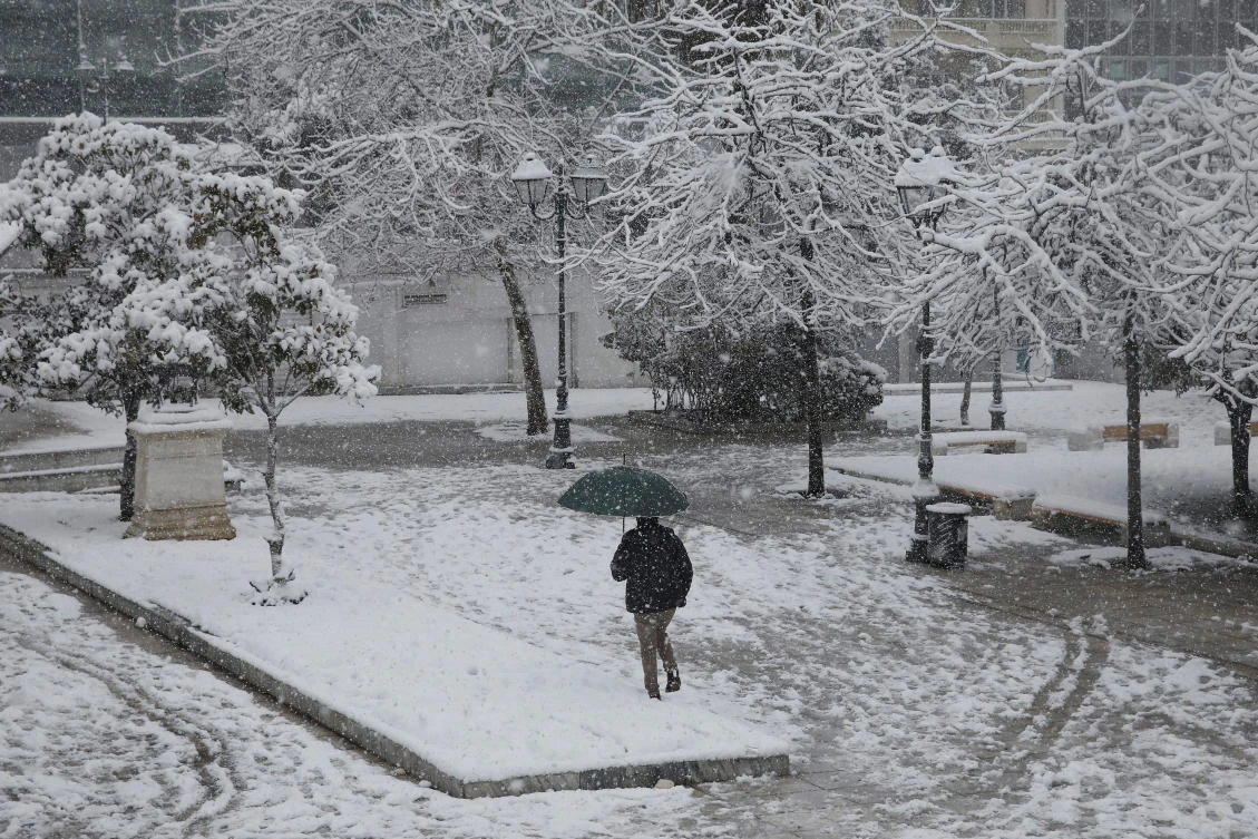 A pedestrian makes his way across the snow-covered Syntagma square amid heavy snowfall in Athens, Greece, February 16, 2021. REUTERS/Costas Baltas