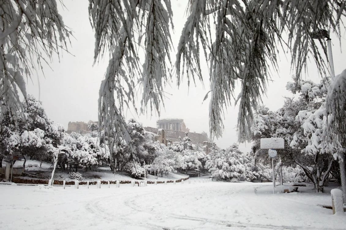 A view of the Parthenon temple atop the Acropolis hill archaeological site during a heavy snowfall in Athens, Greece, February 16, 2021. REUTERS/Costas Baltas