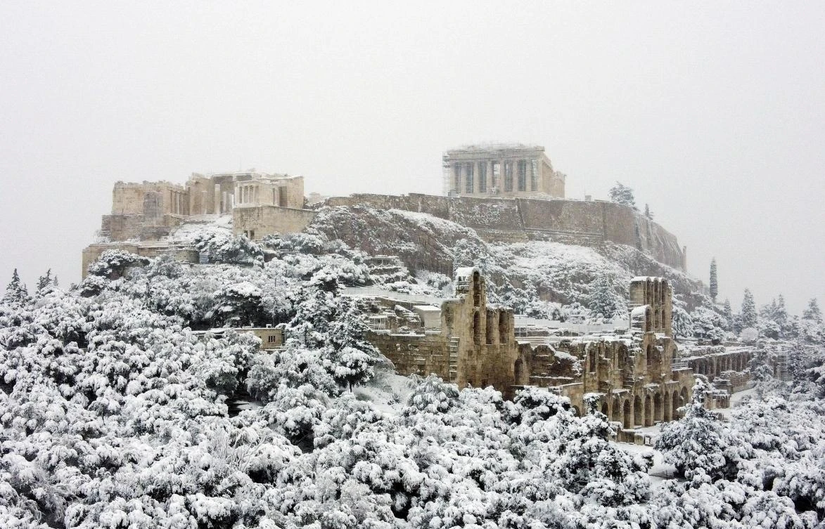 The Parthenon temple is seen atop the Acropolis hill archaeological site during a heavy snowfall in Athens, Greece, February 16, 2021. Picture taken with a drone. REUTERS/Alkis Konstantinidis