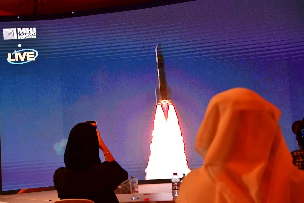 Above, a screen broadcasts the launch of the Hope Mars probe at the Mohammed Bin Rashid Space Centre in Dubai on July 19, 2020. The probe entered into Mars’ orbit on Feb. 9, 2021. (AFP)