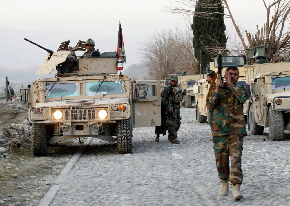 US-led troops will remain in Afghanistan beyond the deadline laid down in a peace deal with the Taliban as the overstretched Afghan National Army comes under continuing attack by militants. (REUTERS/Parwiz)