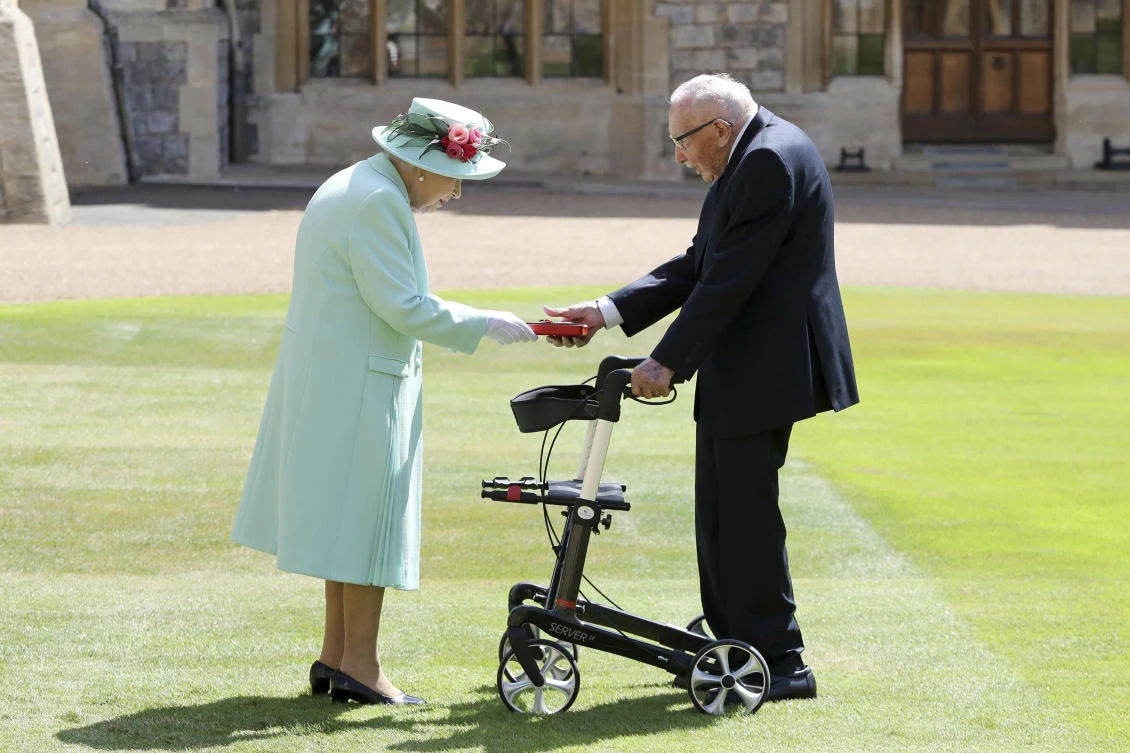 Capt. Sir Tom Moore receiving his knighthood from Britain's Queen Elizabeth, during a ceremony at Windsor Castle in Windsor, England. (Chris Jackson/Pool Photo via AP, File)