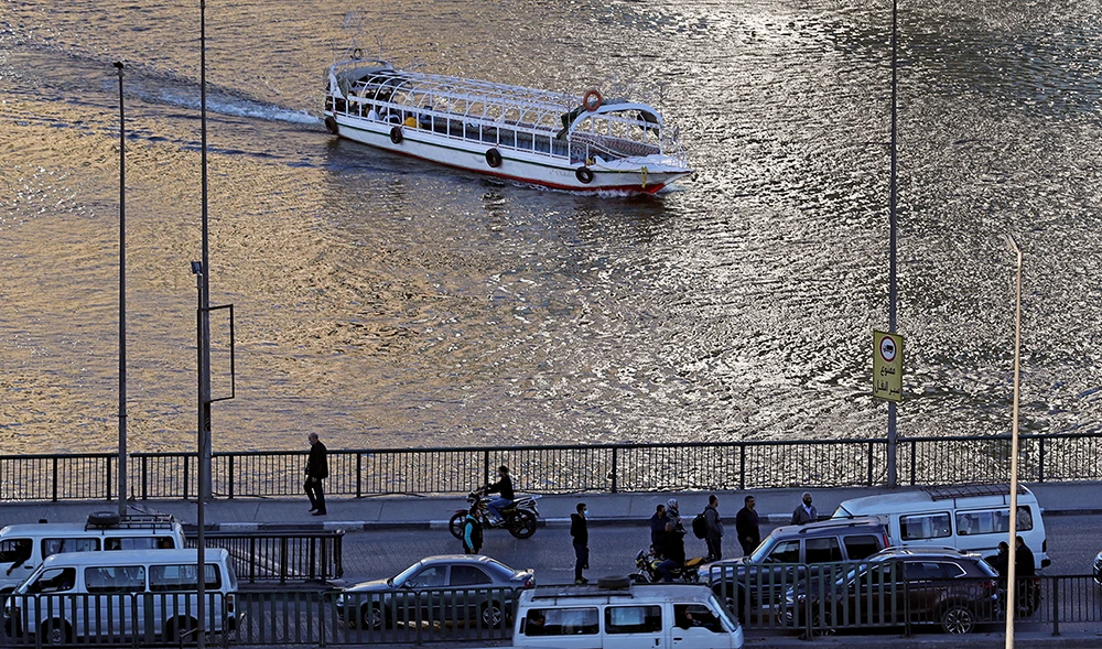 A boat approaches the 15th May Bridge, which spans over the River Nile, in Cairo, Egypt January 30, 2021. (Reuters)