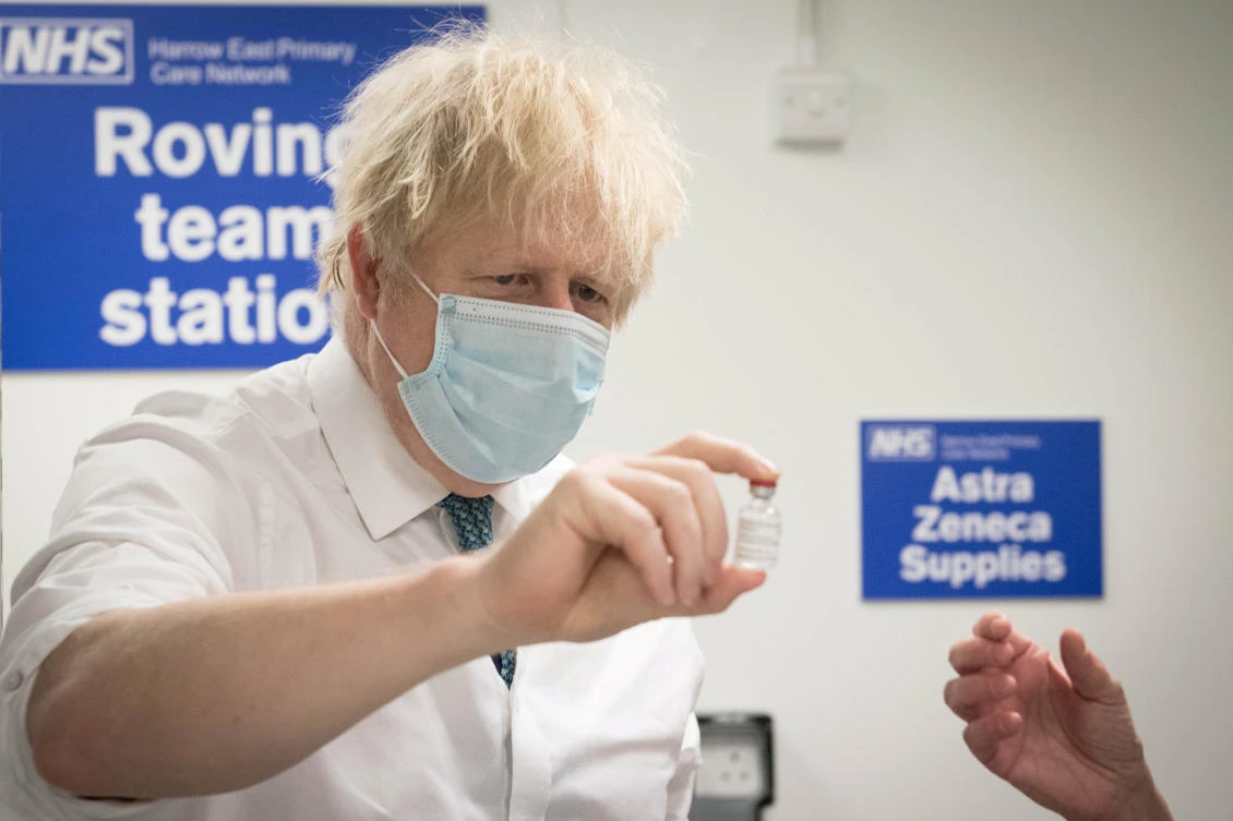 Boris Johnson sees how a dose of the Oxford/AstraZeneca COVID-19 vaccine is prepared for a mobile vaccination center in northern England. (Reuters)