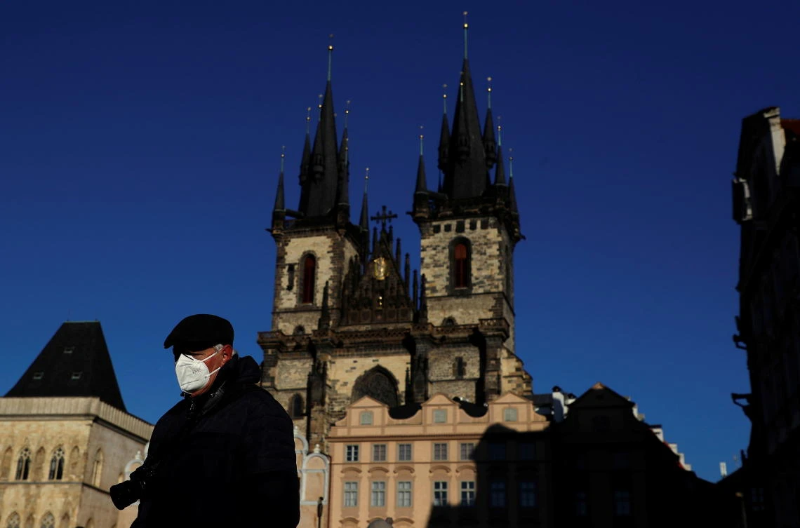 A man wearing a face mask walks across the Old Town Square amid the coronavirus disease (COVID-19) outbreak in Prague, Czech Republic, January 31, 2021. (Reuters)