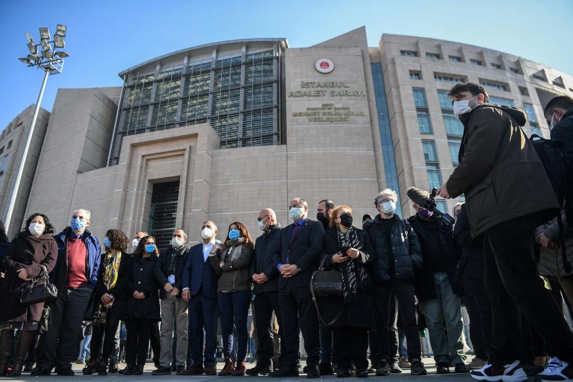 Turkish-French journalist Erol Onderoglu (3R), Reporters Without Borders (RSF) representative in Turkey and activists gather to speak to the press in front of Istanbul's courthouse building on February 3, 2021, before his trial for "terrorist propaganda". (AFP)