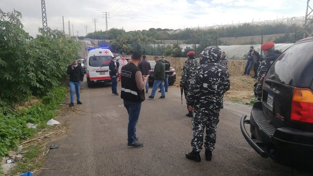 Police gather at the side where the body of anti-Hezbollah journalist and activist Luqman Slim was found in his car. (Reuters)