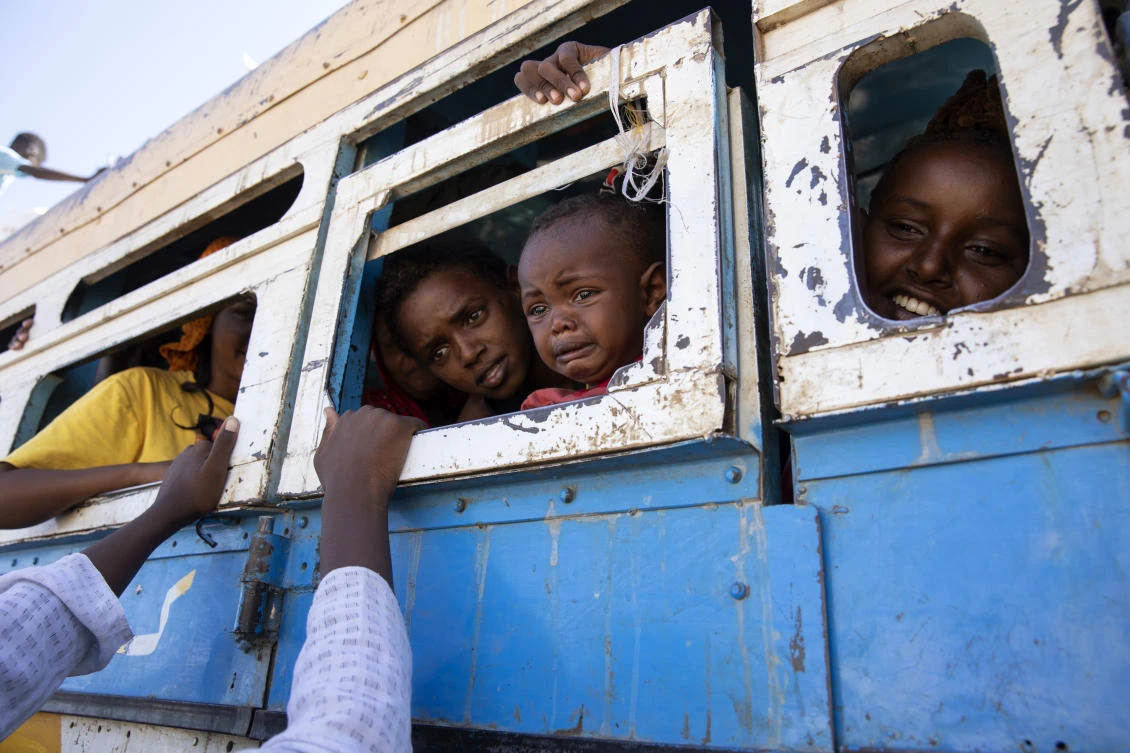 Refugees who fled the conflict in Ethiopia’s Tigray region ride a bus going to the Village 8 temporary shelter, near the Sudan-Ethiopia border, in Hamdayet, eastern Sudan, Dec. 1, 2020. (AP Photo)