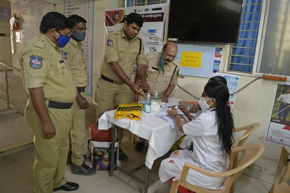 Police personnel verify their names with medical staff before receiving Covid-19 coronavirus vaccine at the public health centre in Hyderabad on February 6, 2021. (AFP)