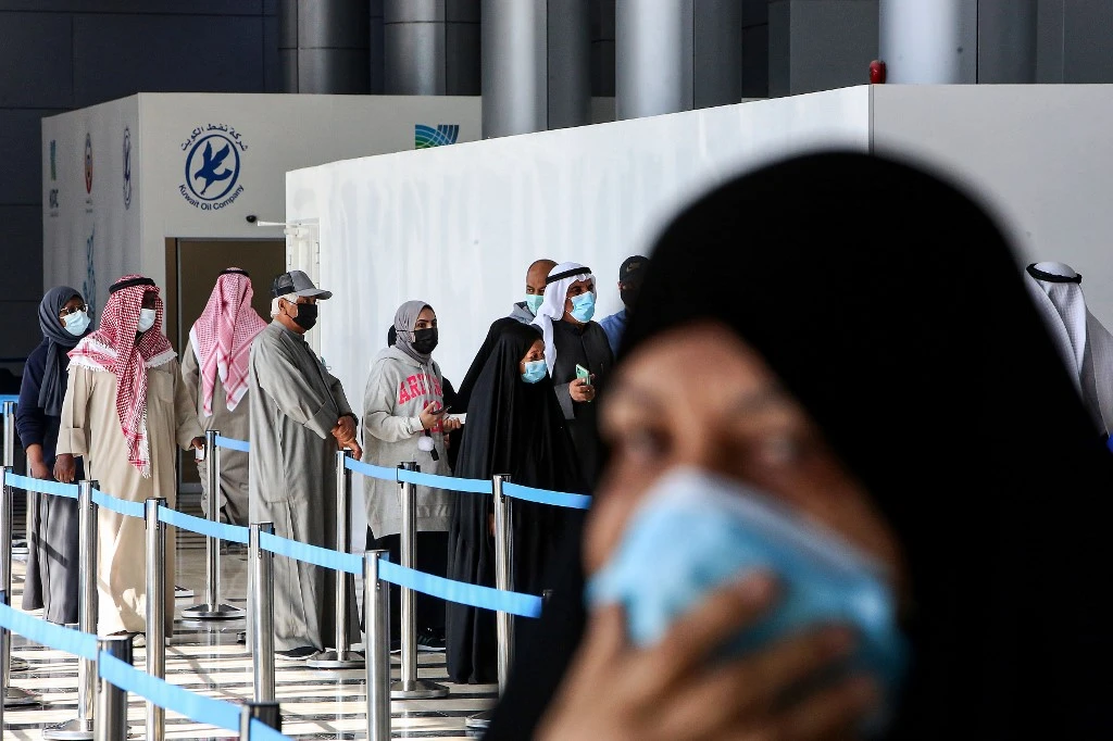 People queue to receive COVID-19 coronavirus vaccine at the Kuwait International Fairground on Feb. 1, 2021. (AFP)