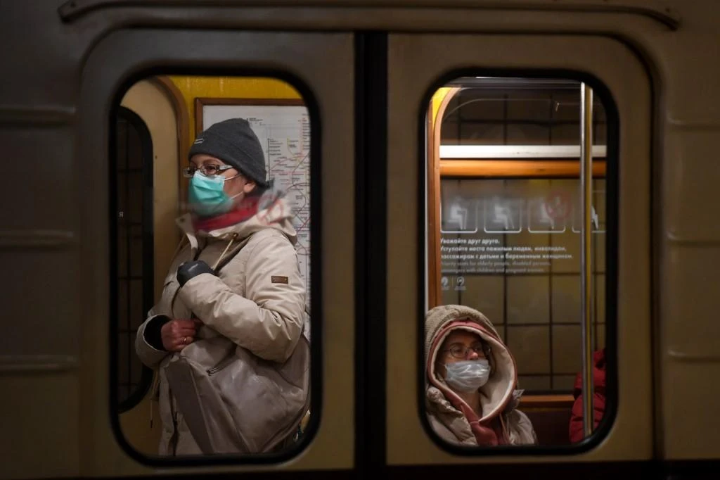 Above, commuters wear face masks to protect against the coronavirus disease on a metro train in Moscow. (AFP file photo)