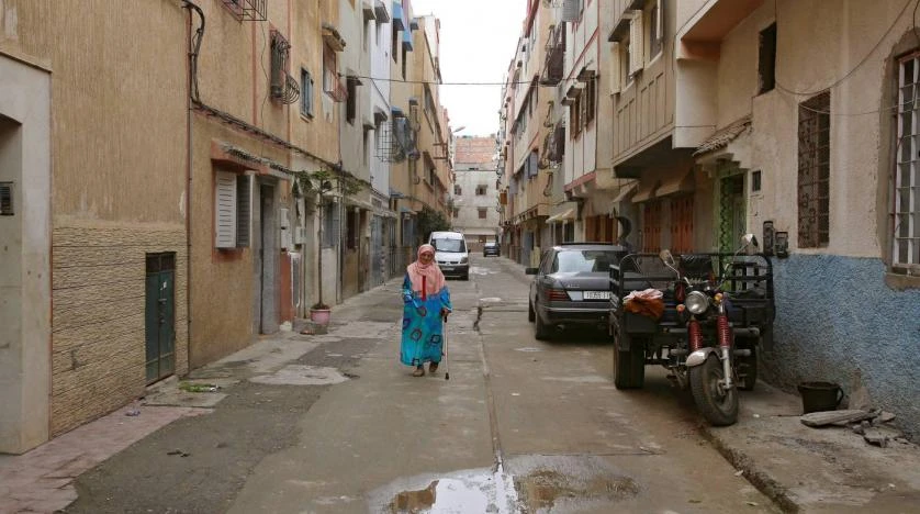 A woman walks along a narrow street in Ouled Moussa district, on the outskirts of Rabat, Morocco April 24, 2018. Picture taken April 24, 2018. (Reuters)