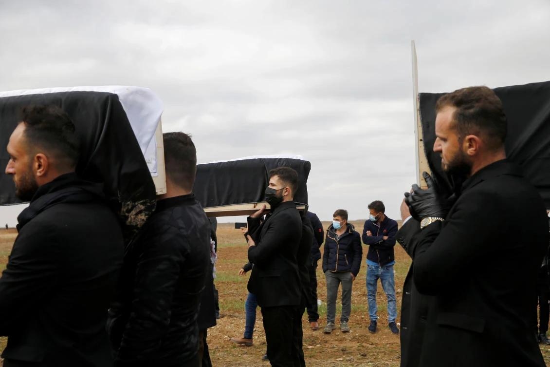 Thikran Kamiran Yousif, 22, carries a coffin with the remains of his father from the minority Yazidi sect, who was killed by Daesh militants, after they were exhumed from a mass grave, to bury them in Kojo, Iraq. (Reuters)