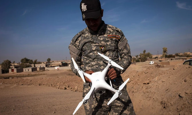 An Iraqi policeman holds a drone near the village of Arbid, on the southern Mosul front, Nov. 12, 2016, during the ongoing military operation to retake Mosul from Daesh. (AFP)