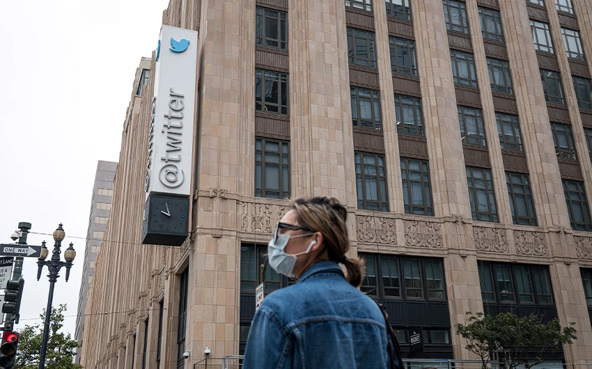 A woman stands in front of the headquarters of the social network Twitter in California, The United States of America, on October 13, 2017. (Photo courtesy: Getty Images)