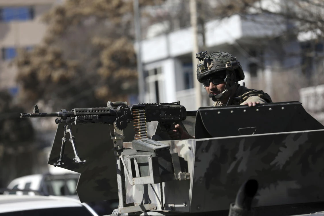 Above, a security personnel on guard in Kabul, which has seen near-daily attacks during the busy morning commute. (AP)
