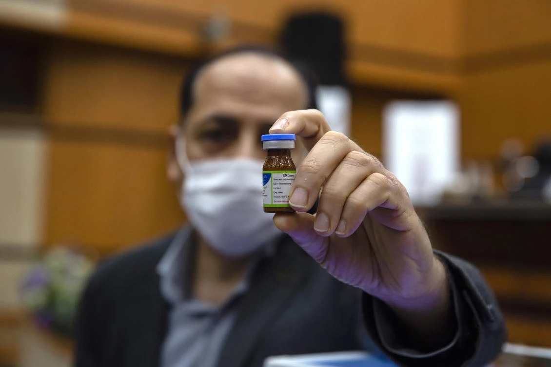 An Iranian official holds a vial of the Iranian-made Razi Cov Pars coronavirus vaccine during an unveiling ceremony at the Razi Vaccine Research Institute on Feb. 8, 2021. (AP)
