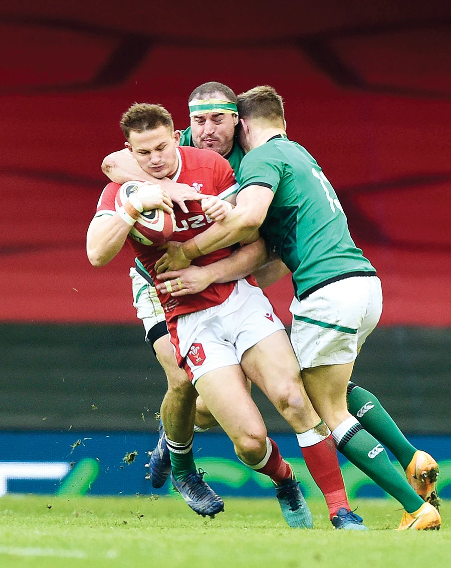Ireland’s Rob Herring and Garry Ringrose in action with Wales’ Hallam Amos in Cardiff on Sunday. (Reuters)