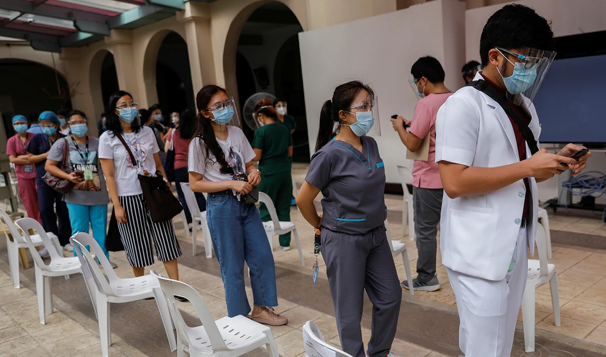 Health workers and employees of Philippine General Hospital queue to register for COVID-19 vaccines, expected to arrive this month, at the Philippine General Hospital in Manila, Philippines, February 9, 2021. (Reuters)