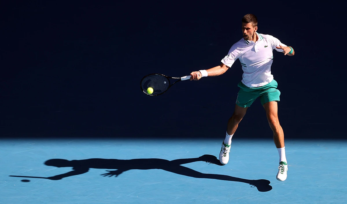 Serbia's Novak Djokovic hits a return on day three of the Australian Open. (AFP)