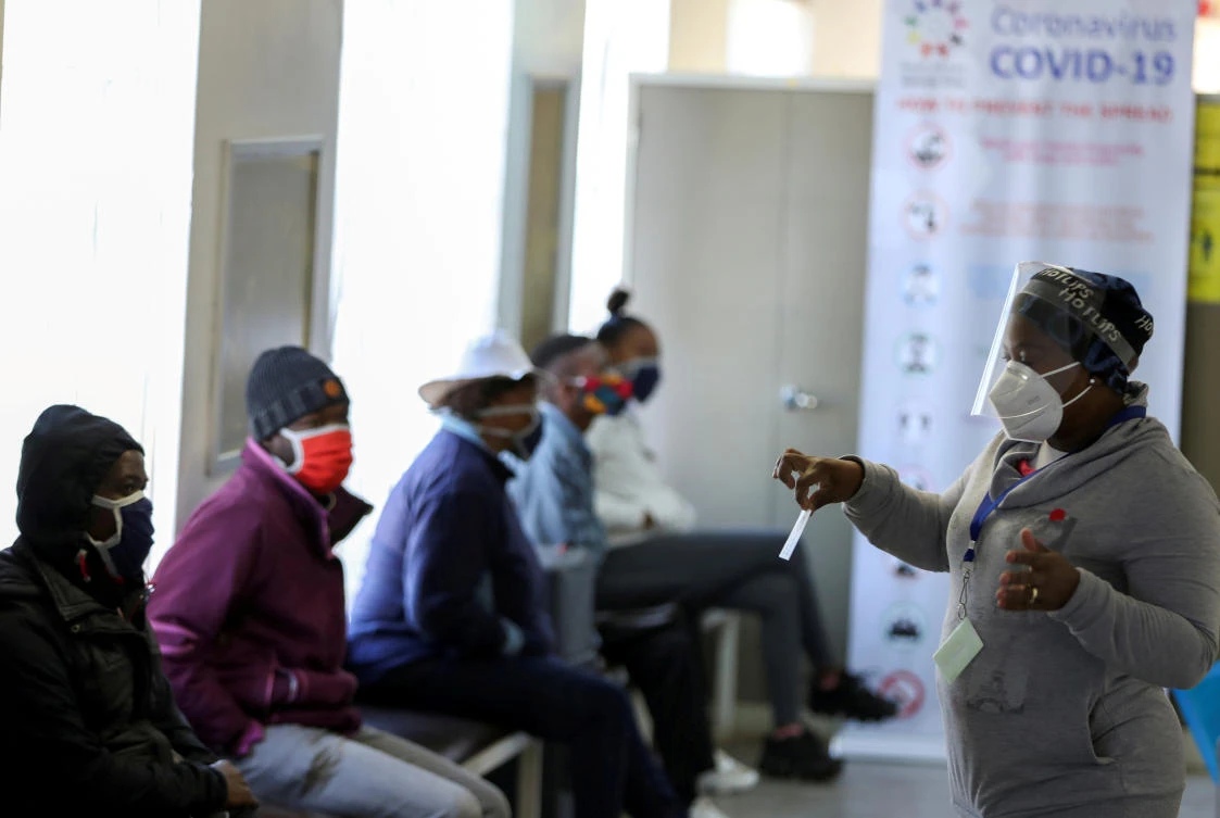 FILE PHOTO: A medical worker talks to volunteers as they wait to receive an injection during the country's first human clinical trial for a potential vaccine against the novel coronavirus, at the Baragwanath hospital in Soweto, South Africa, June 24, 2020. REUTERS/Siphiwe Sibeko//File Photo