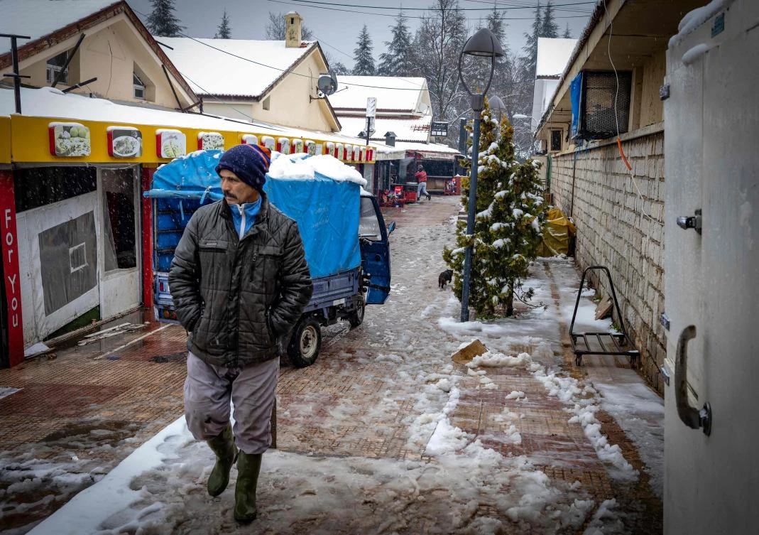 A walks near the central market in the town of Ifrane, the capital of Morocco's northern Ifrane province in the Atlas mountains, on February 7, 2021. (AFP)