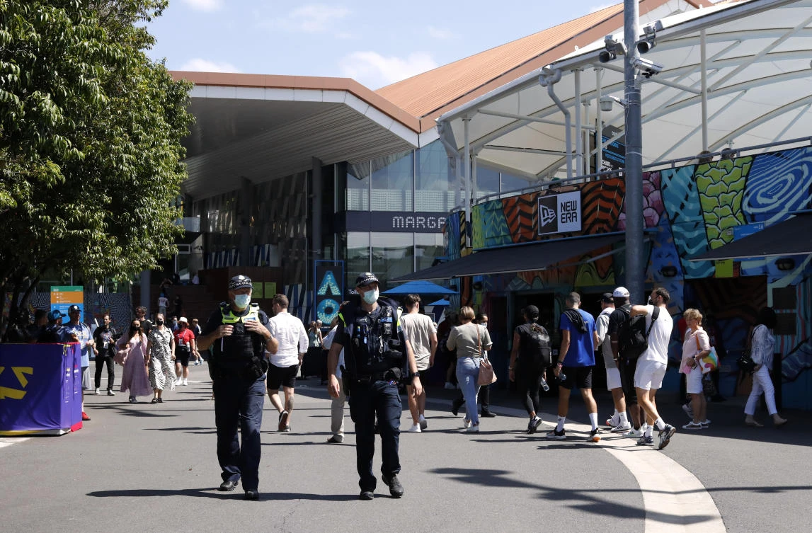 Above, police officers at Melbourne Park where the Australian Open open is being held. The tournament will proceed without crowds over the next five days after a fresh lockdown. (Reuters)