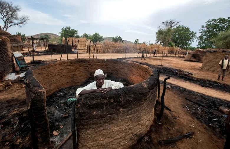 A man is seen inside a burnt house during clashes between nomads and residents in Deleij village, Wadi Salih province, Central Darfur, Sudan, June 11, 2019. (Reuters)
