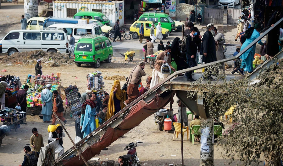 People embark on a foot-over bridge to enter in Rawalpindi from Islamabad on February 9, 2021. (AFP)