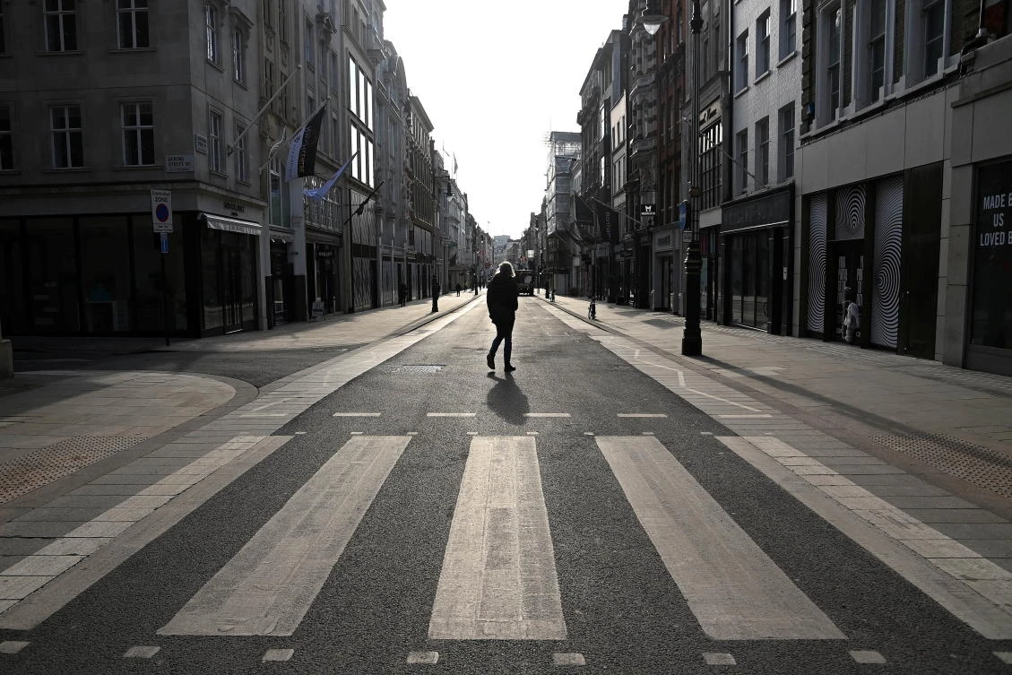 A person crosses an almost empty New Bond Street, as official figures are published for UK GDP in 2020, London, Britain, February 12, 2021. (Reuters)