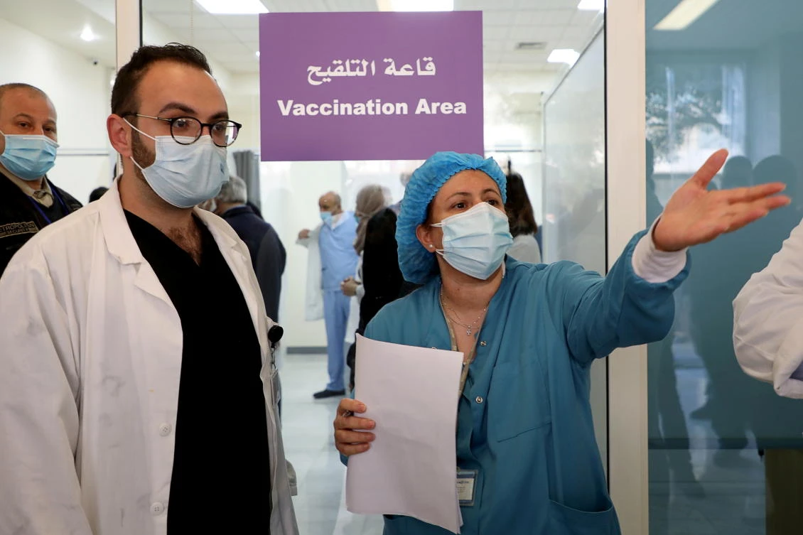 A healthcare worker gestures during a coronavirus vaccination campaign, at Rafik Hariri University Hospital, in Beirut, Lebanon February 14, 2021. (Reuters)