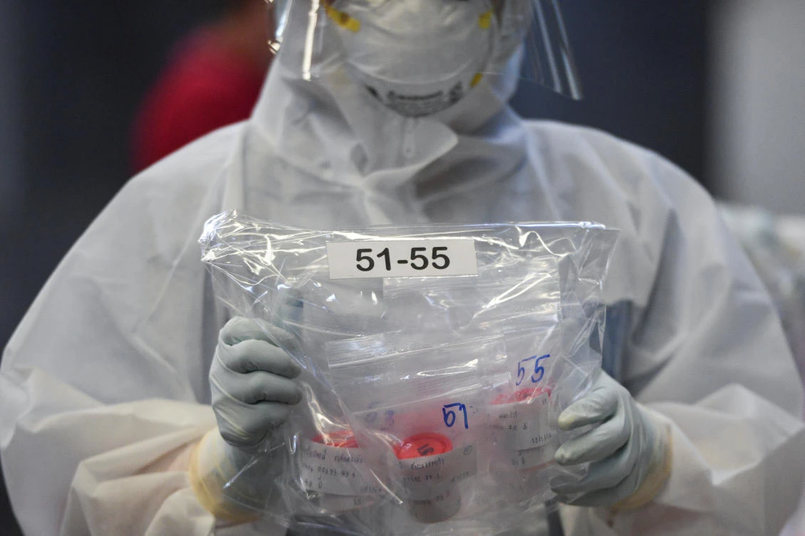 Above, a health worker organizes samples collected for further testing amid the spread of the coronavirus disease in Thailand. (Reuters)