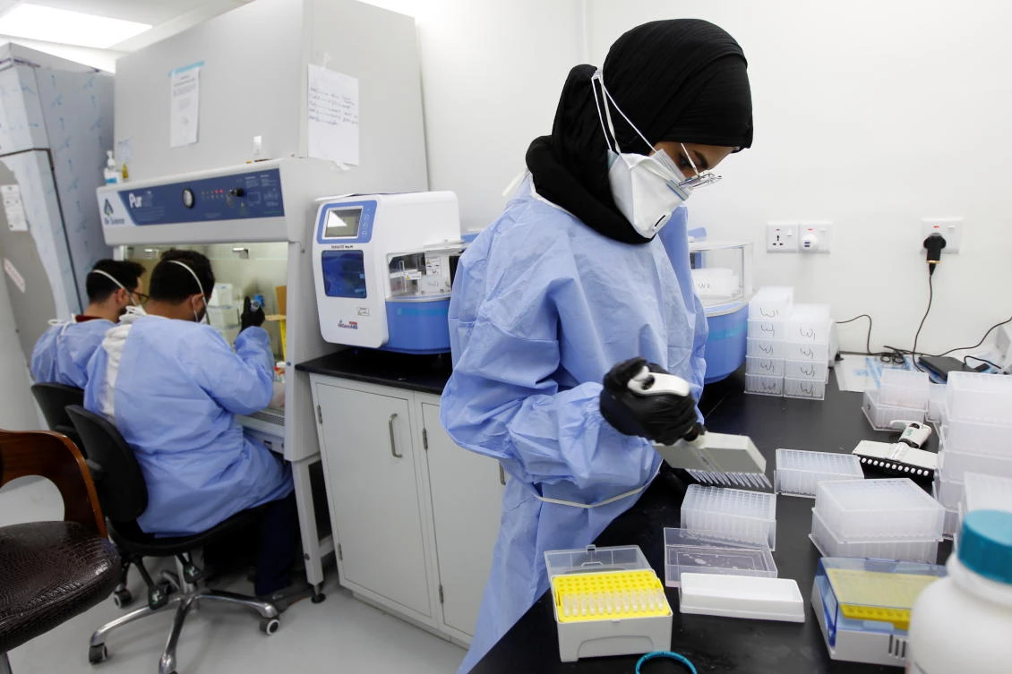 A medical team member wearing a protective suit and a face mask, works on blood samples to be tested for coronavirus disease (COVID-19), at a medical center in a hospital in the holy city of Najaf, Iraq February 15, 2021. (Reuters)