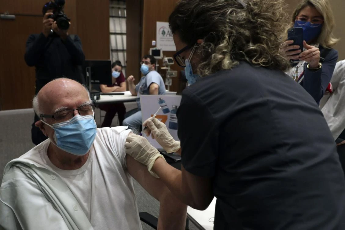 A health care worker receives Pfizer-BioNTech COVID-19 vaccine during a nationwide vaccination program at the American University Medical Center in Beirut, Lebanon, Feb. 14, 2021. (AP Photo)