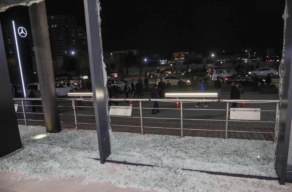 Shattered glass is pictured on the floor of a shop following a rocket attack in Irbil, the capital of the northern Iraqi Kurdish autonomous region, on Feb. 15, 2021. (AFP)