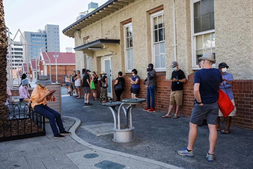 Australia’s regulator has now approved two coronavirus vaccines for use: the AstraZeneca jab and Pfizer’s product. Above, Perth residents wait to be tested for COVID-19. (AFP)