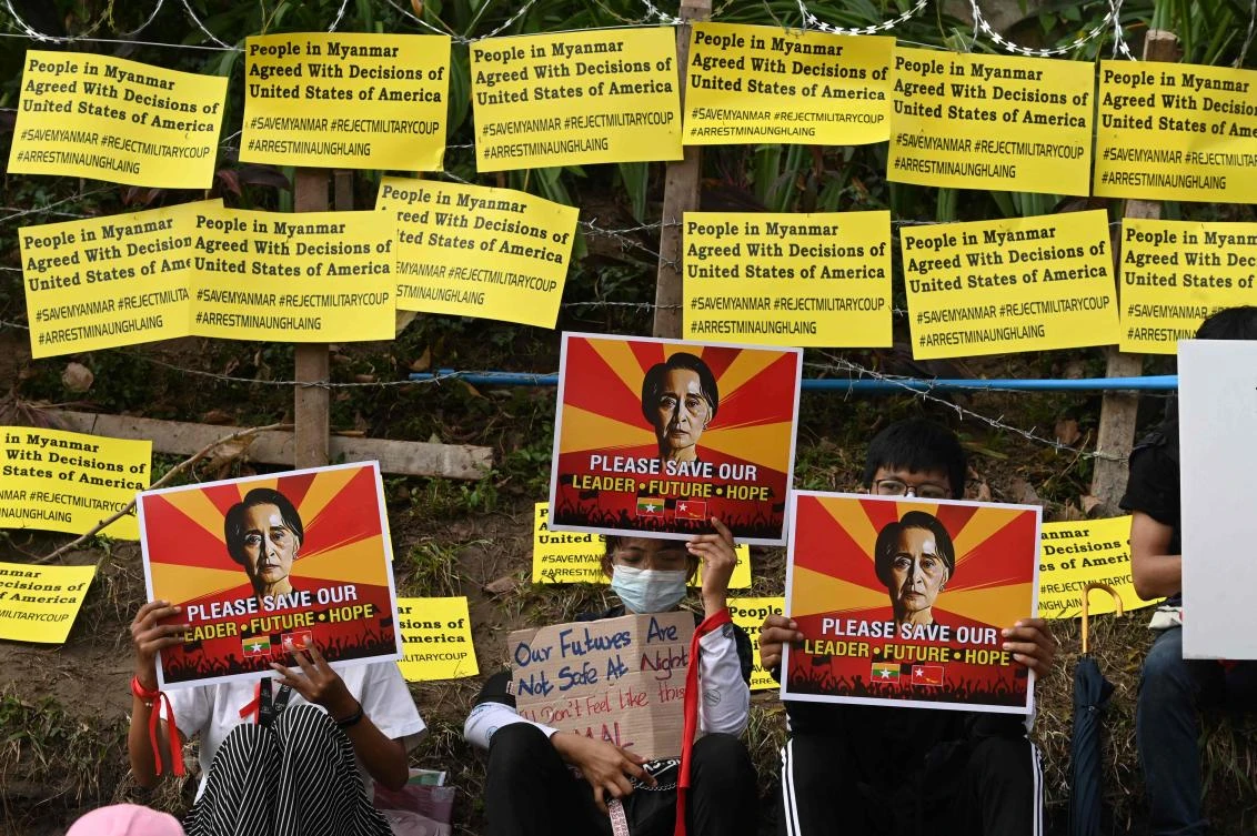 Protesters holds up posters with an image of detained Myanmar leader Aung Saan Suu Kyi during a demonstration against the military coup in front of US embassy in Yangon on Feb. 16, 2021. (AFP)