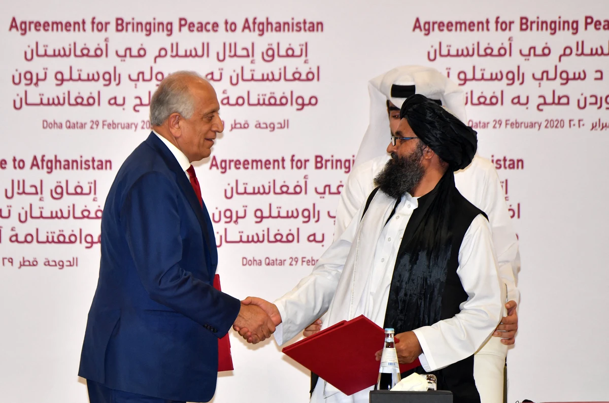(L to R) US Special Representative for Afghanistan Reconciliation Zalmay Khalilzad and Taliban co-founder Mullah Abdul Ghani Baradar shake hands after signing a peace agreement during a ceremony in the Qatari capital Doha on February 29, 2020. (AFP)