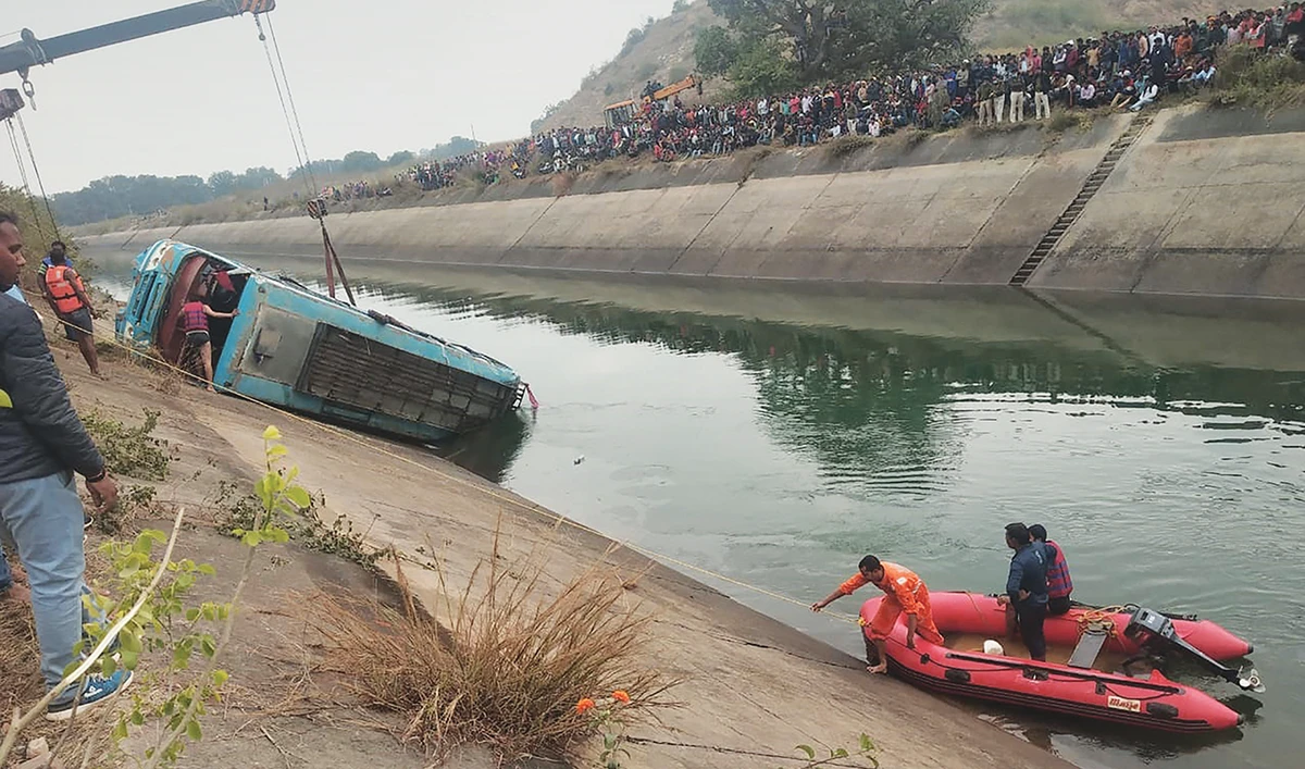 Onlookers stand along a canal as rescue teams search for survivors after a bus plunged into a canal killing at least 37 passengers, in Sidhi district of Madhya Pradesh state on Tuesday. (AFP)