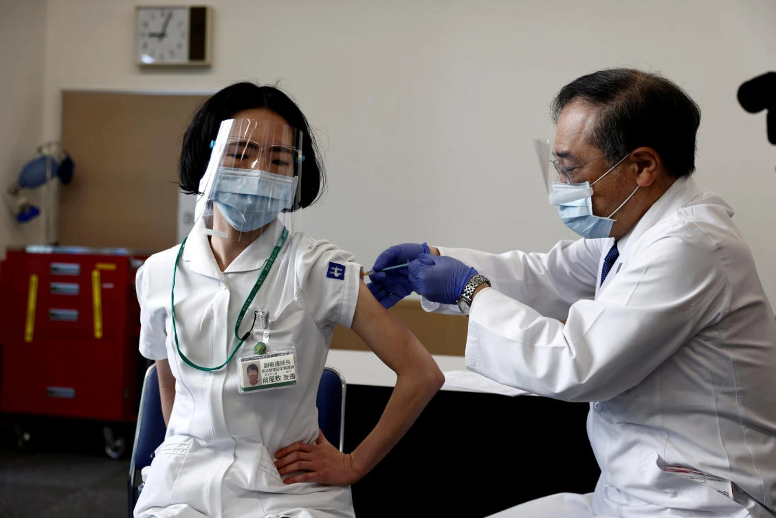 A medical worker receives a dose of the coronavirus disease vaccine as Japan launches its inoculation campaign on Feb. 17, 2021. (Reuters)