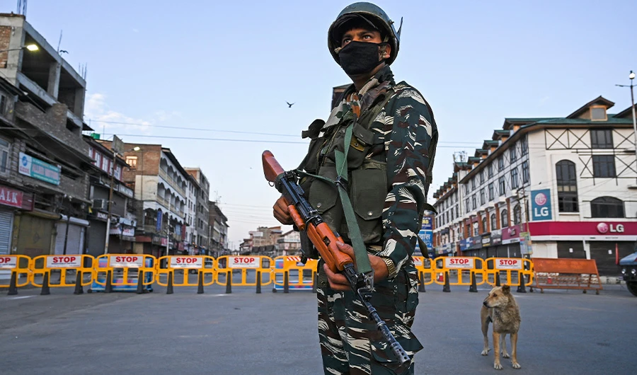 A paramilitary soldier stands guard at a checkpoint during a curfew in Srinagar on August 4, 2020. (AFP)
