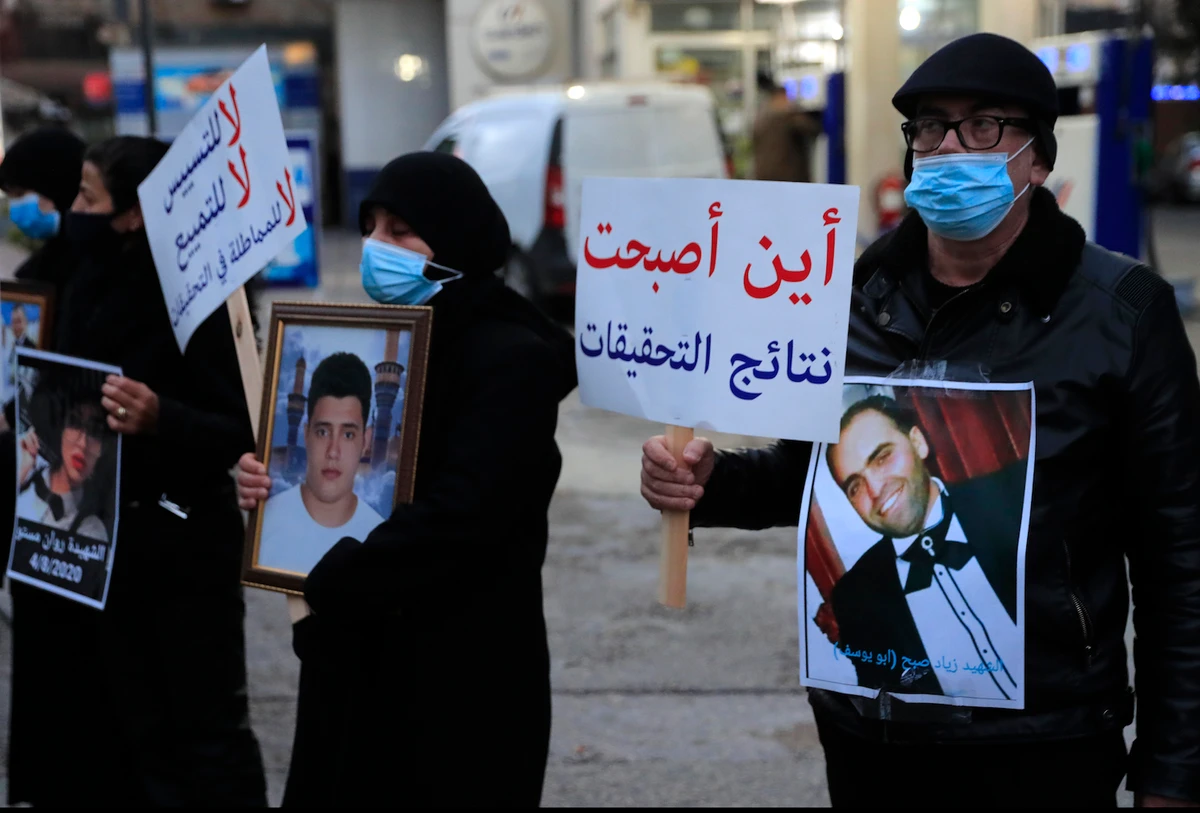 Relatives of victims of the Beirut port explosion during a sit-in outside the Justice Palace, in Beirut on Thursday, Feb. 18, 2021. (AP)