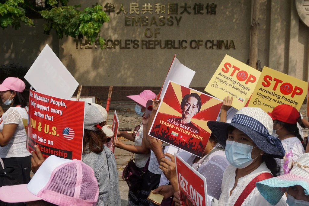 Protesters hold up signs during a demonstration against the military coup in front of the Chinese Embassy in Yangon on February 18, 2021. (AFP/File Photo)