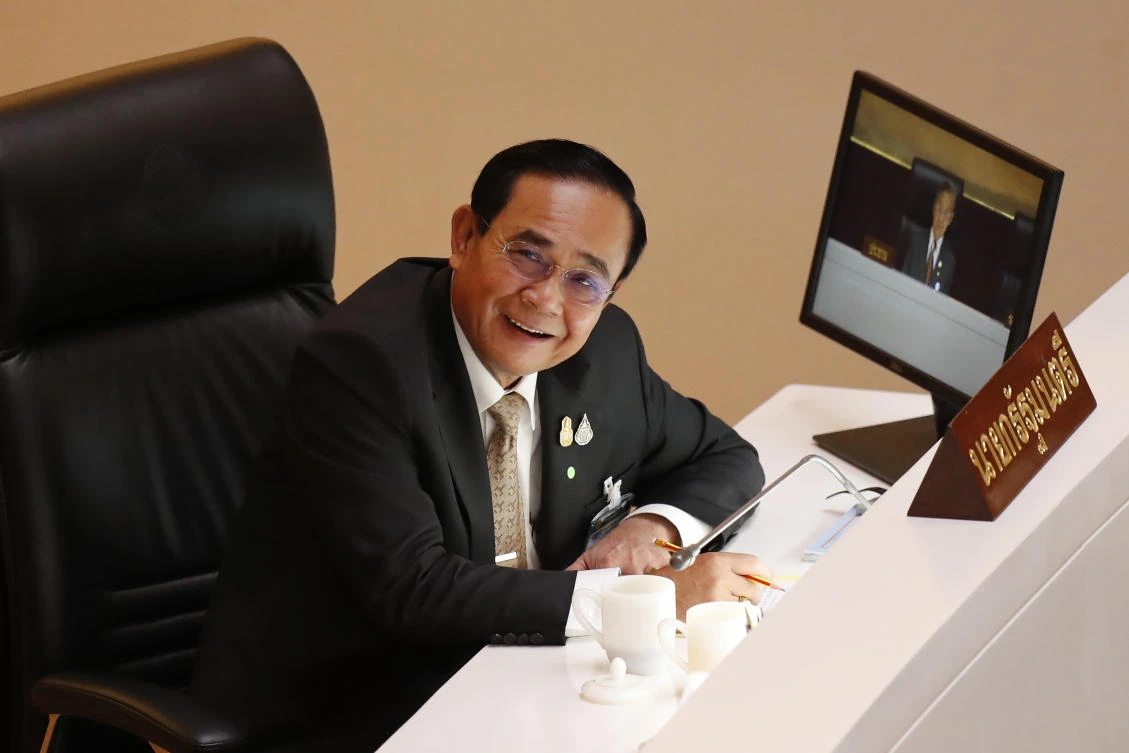 Thailand Prime Minister Prayuth Chan-ocha smiles in parliament after a no-confidence vote against him was defeated in Bangkok, Thailand Saturday, Feb. 20, 2021. (AP)