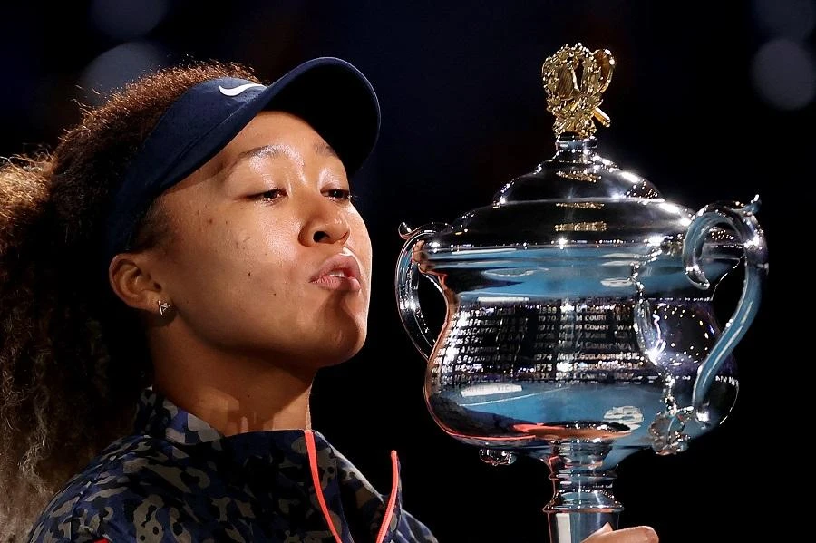 Japan's Naomi Osaka kisses the Daphne Akhurst Memorial Cup trophy after beating Jennifer Brady of the US to win their women's singles final match on day thirteen of the Australian Open tennis tournament in Melbourne on February 20, 2021. (File/AFP)