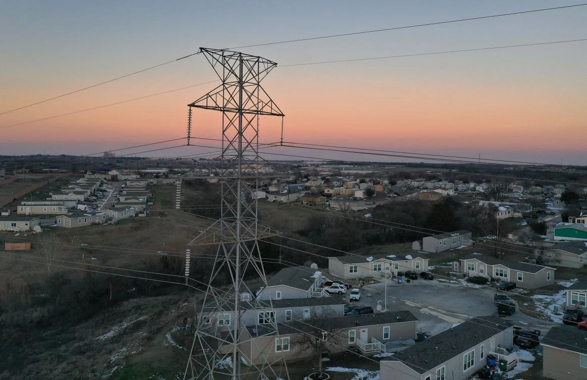 An aerial view from a drone shows electrical lines running through a neighborhood on February 19, 2021 in Austin, Texas. (AFP)
