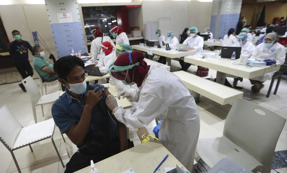 A man receives a shot of COVID-19 vaccine during a mass vaccination for traders at Tanah Abang Market in Jakarta, Indonesia, Thursday, Feb. 18, 2021. (AP)