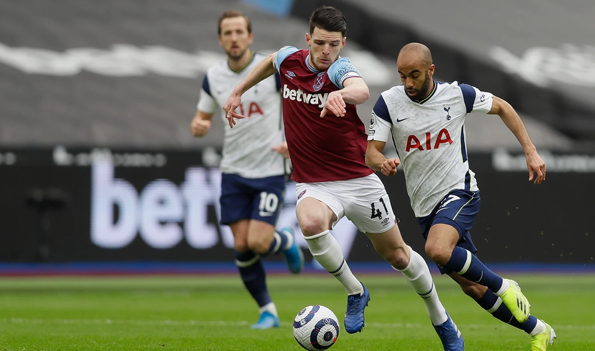 Tottenham’s Lucas Moura, right, duels for the ball with West Ham’s Declan Rice in London on Sunday. (AP)